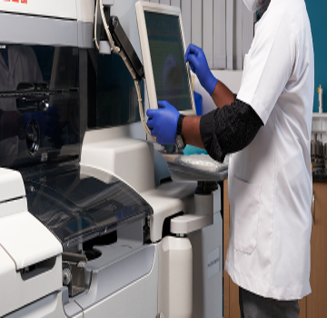 Orange Health lab professional working on diagnostics equipment